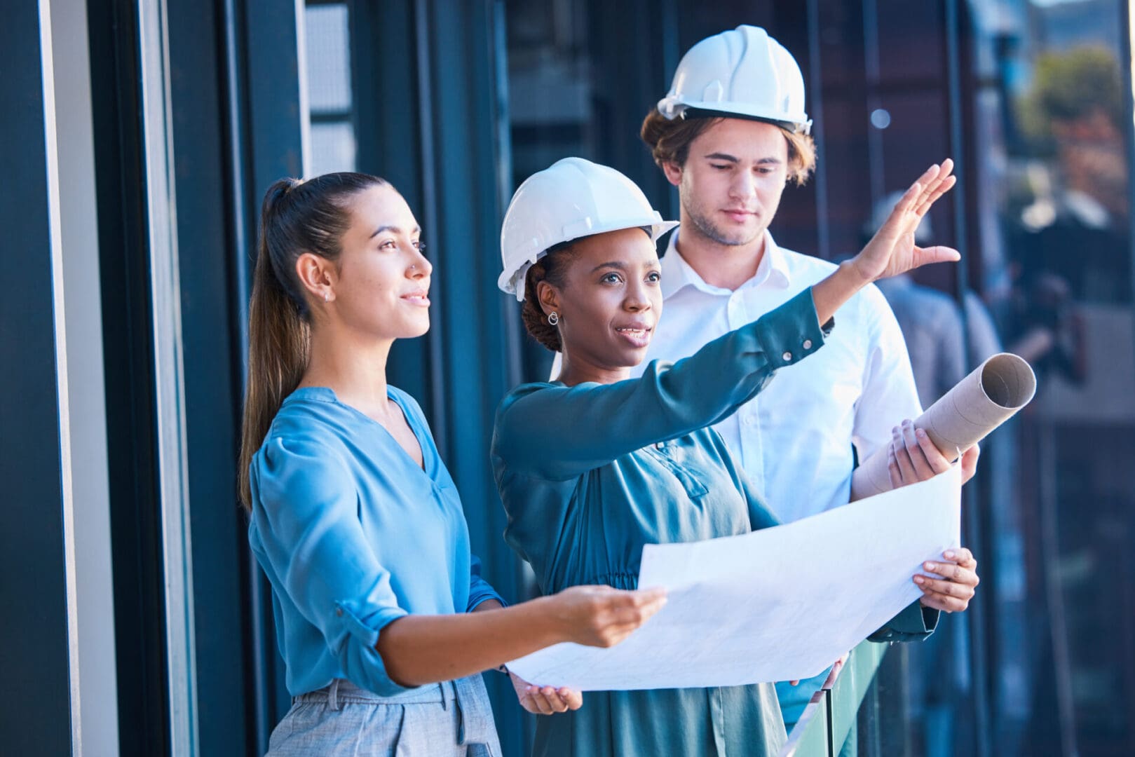 Architects discussing blueprints at construction site.