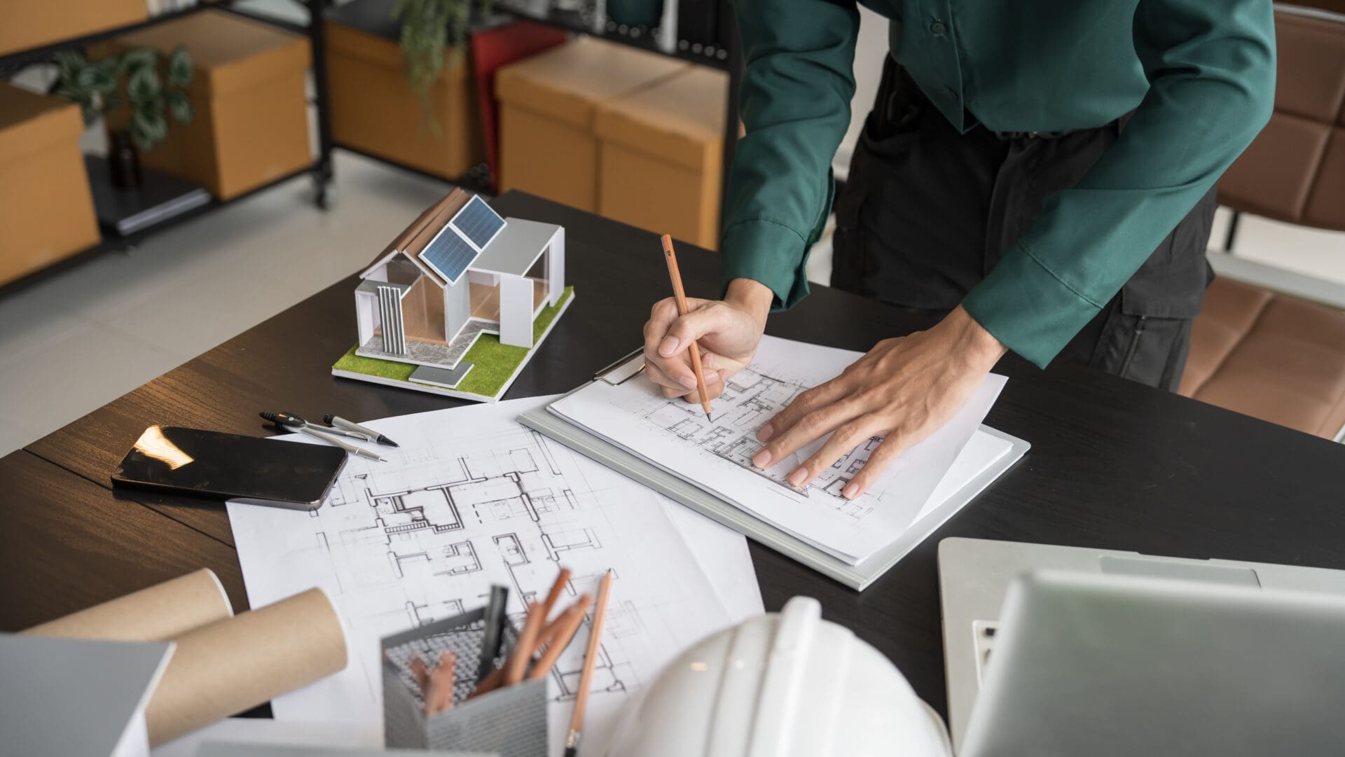 Architect drawing plans at a desk.